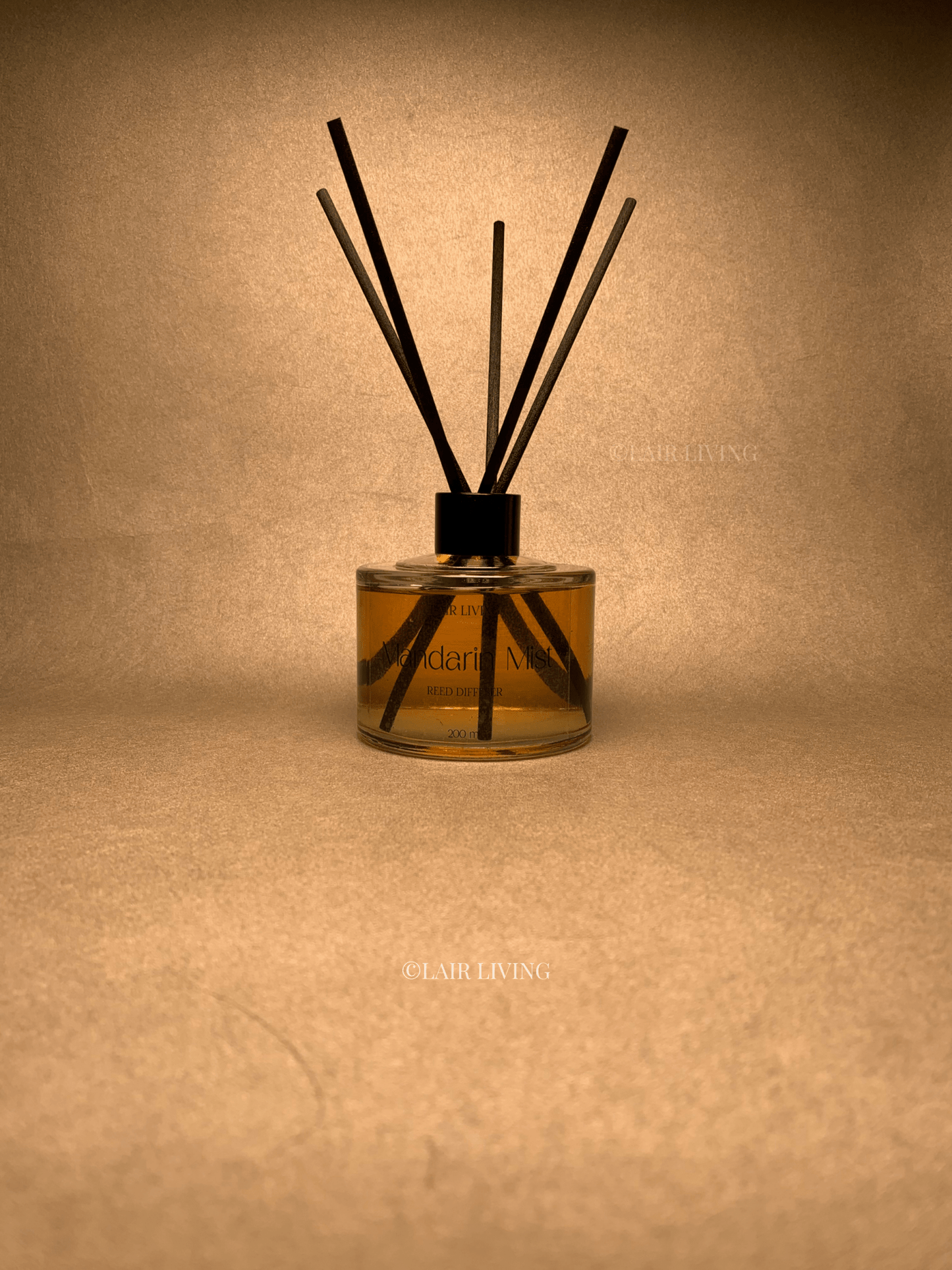 Lair Living Mandarin Mist Reed Diffuser with 8 reed sticks, featuring vibrant citrus scents for a refreshing home fragrance. Best in India for luxury living and gifting.