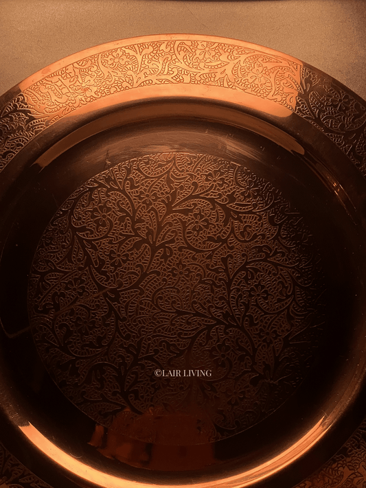 Lair Living's luxury pure copper charger plate with intricate edged design, ideal for fine dining. This premium copper plate enhances any dining table with elegance and style. Best in India for luxury tableware and gifting.