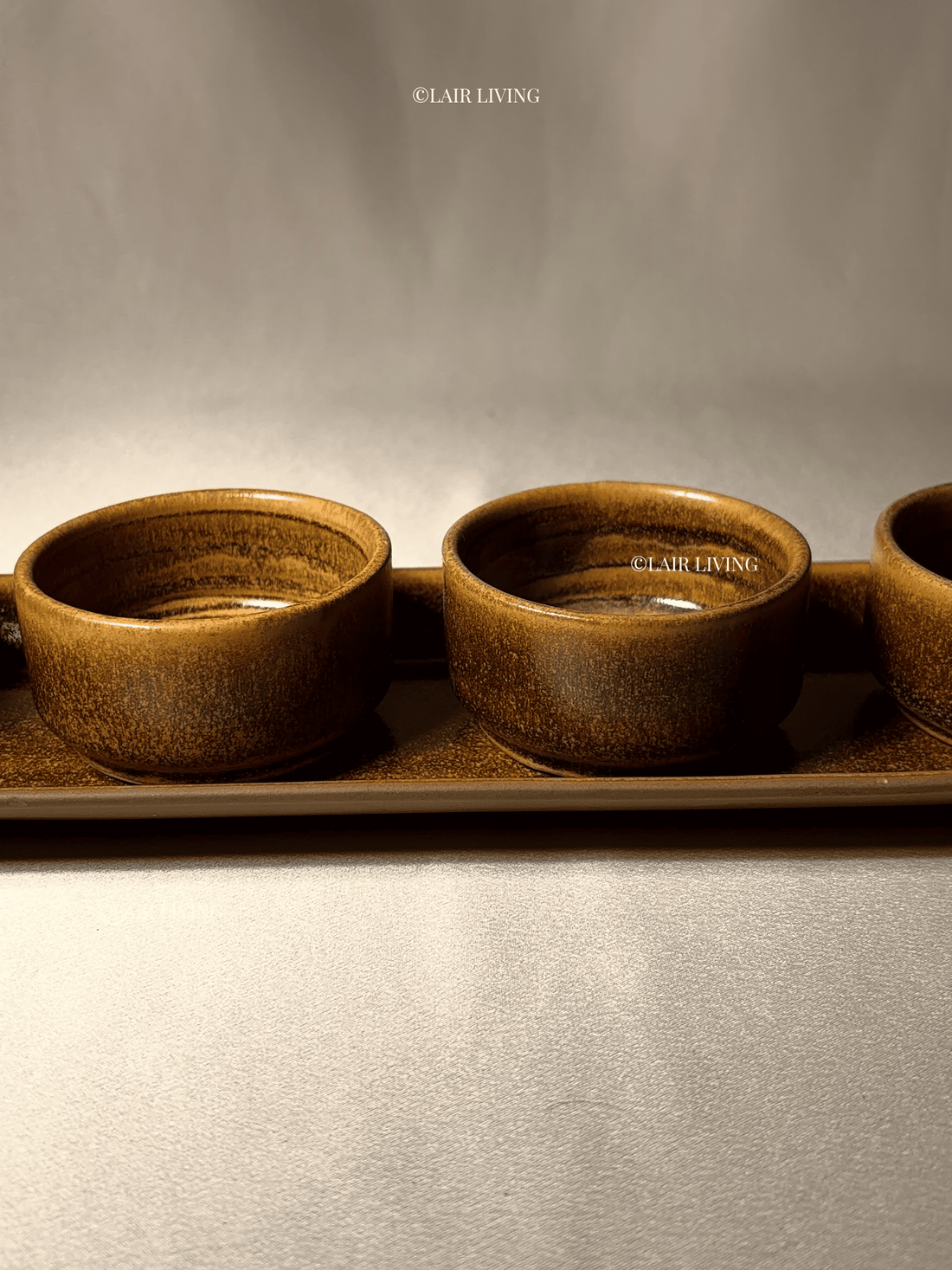 Styling a dinner table with handmade ceramic and brass together - Lair Living India