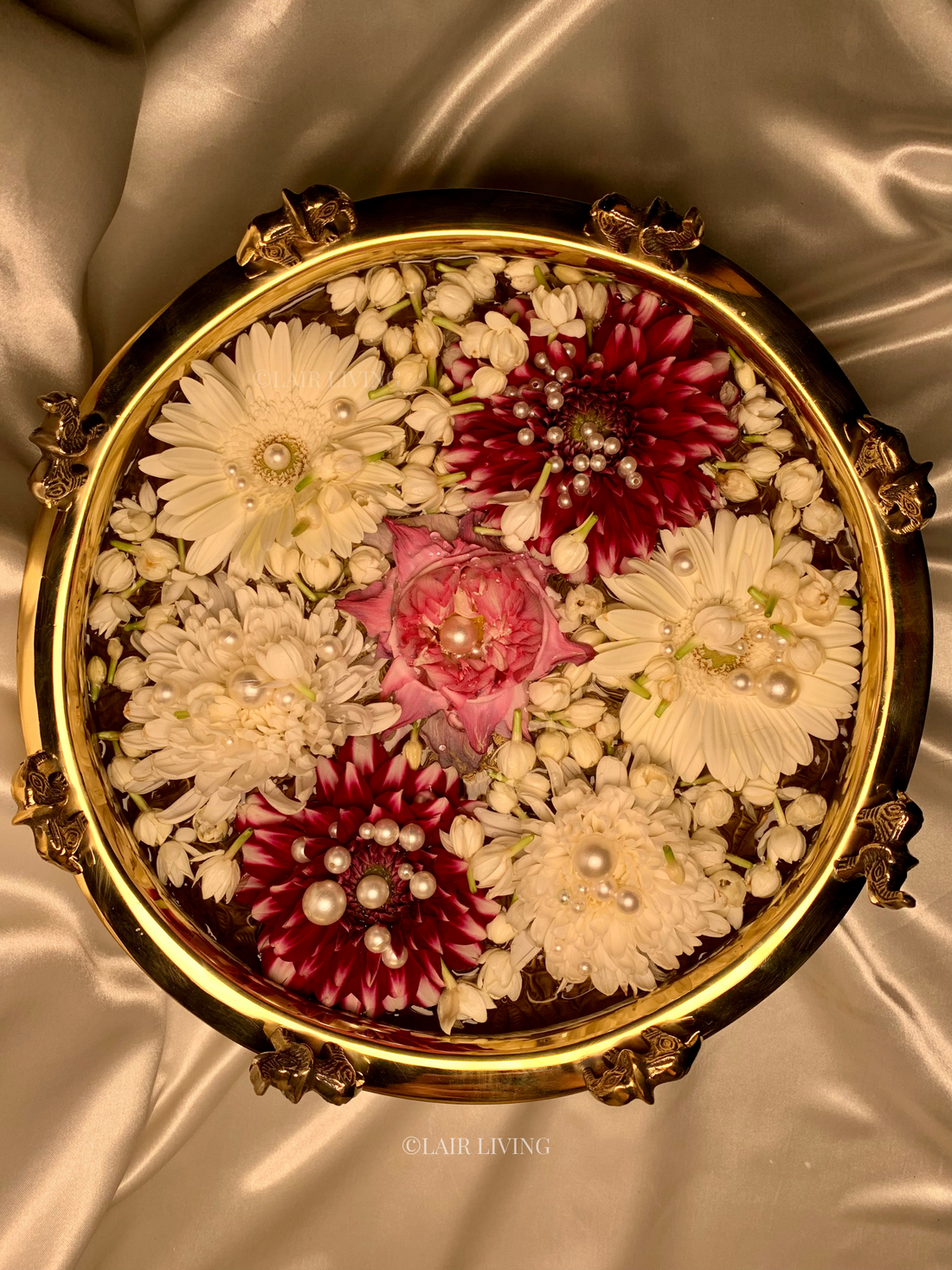 Brass urli with water and floating diyas as a Diwali diya decoration idea