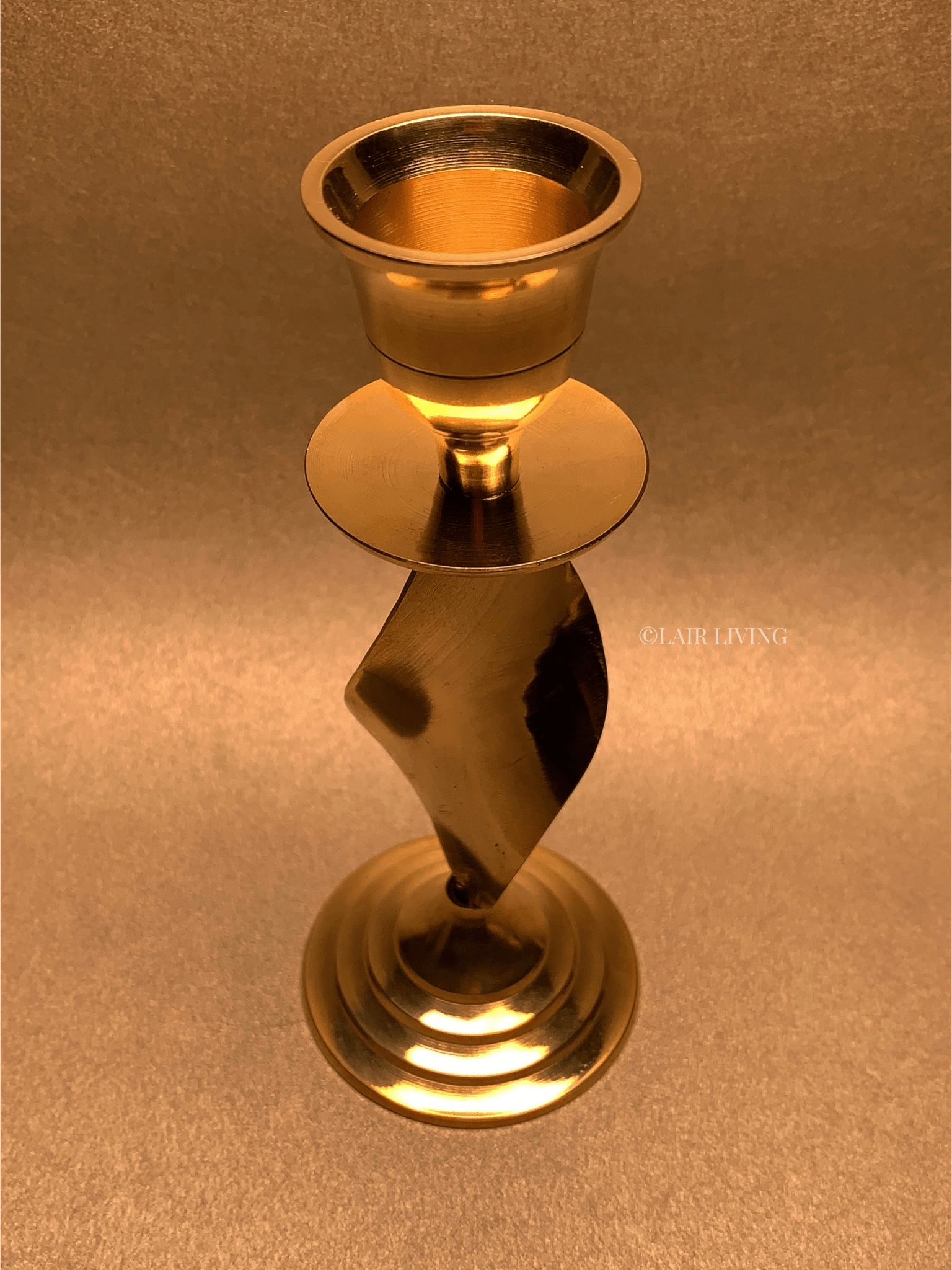 Elegant pure brass tapered candle stand by Lair Living, perfect for luxury home decor and special occasions. Adds a warm, sophisticated ambiance to any room. Best in India for luxury gifting and decor.