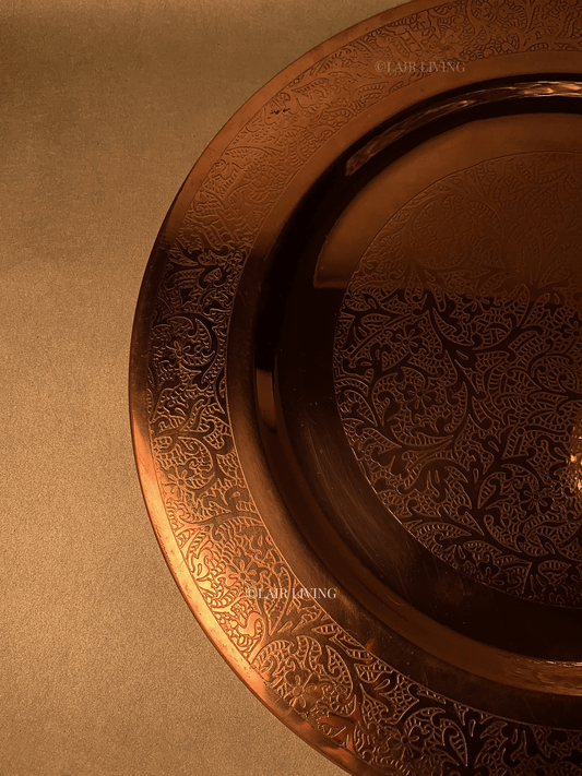 Lair Living's luxury pure copper charger plate with intricate edged design, ideal for fine dining. This premium copper plate enhances any dining table with elegance and style. Best in India for luxury tableware and gifting.